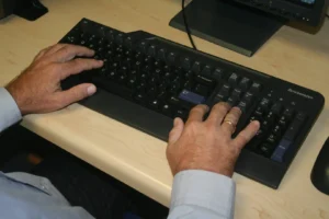 Man typing on a keyboard