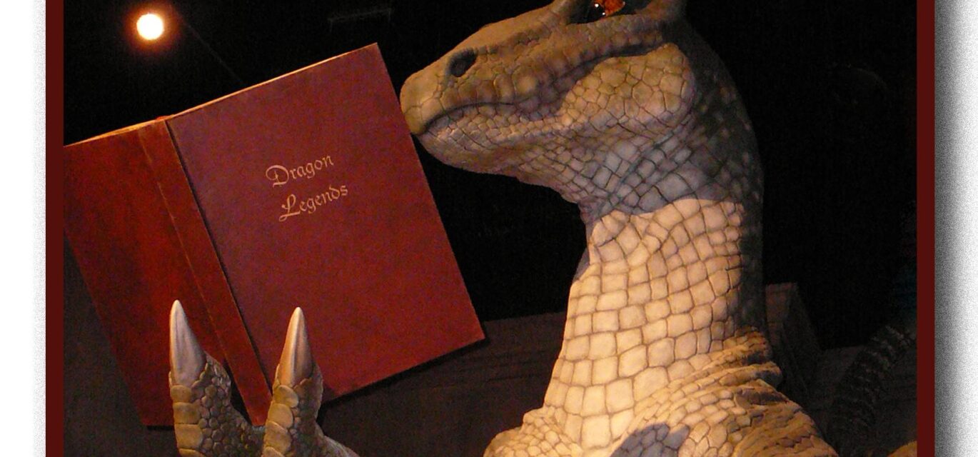 Photo of a dragon reading a book