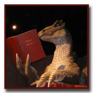 Photo of a dragon reading a book