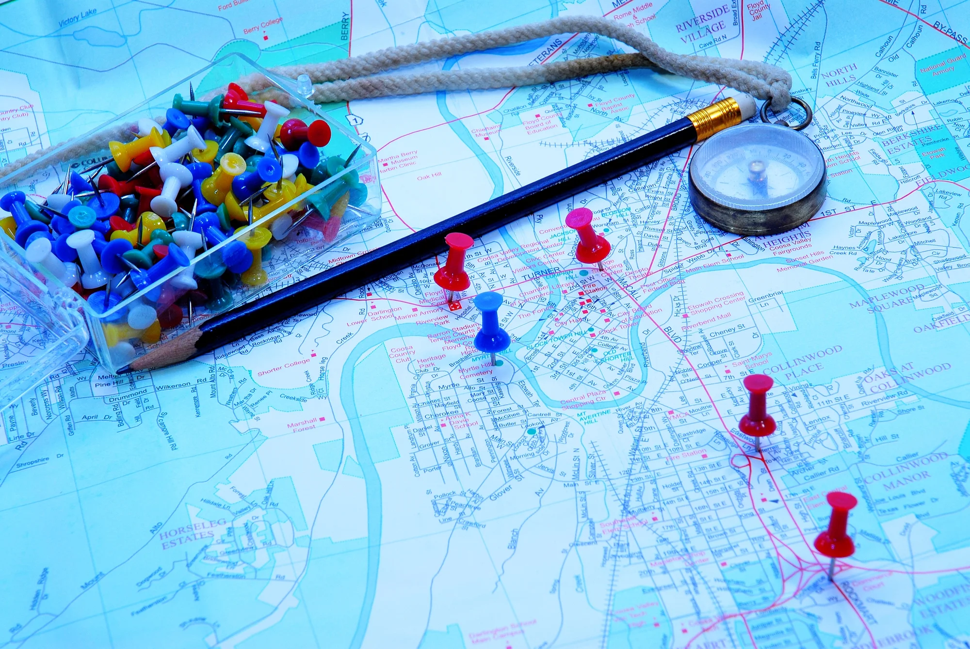 Map With Pins In It And A Pencil On The Top
