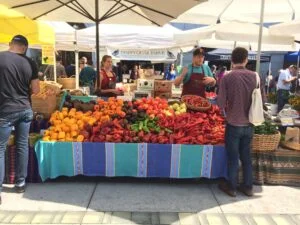 Photo of a farmers market stall full of colourful peppers