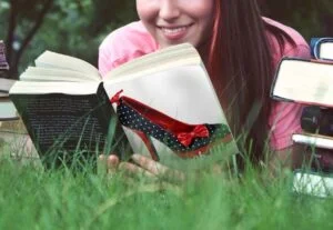 Lady reading a book on the grass
