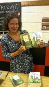 Photo fo Katharine with her books at a public event