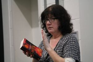 Debbie Young holding a copy of Hugh Howey's Wool