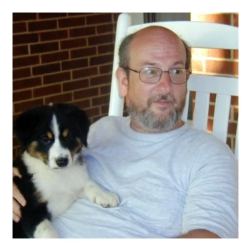 Headshot Of Jim With A Pet Dog