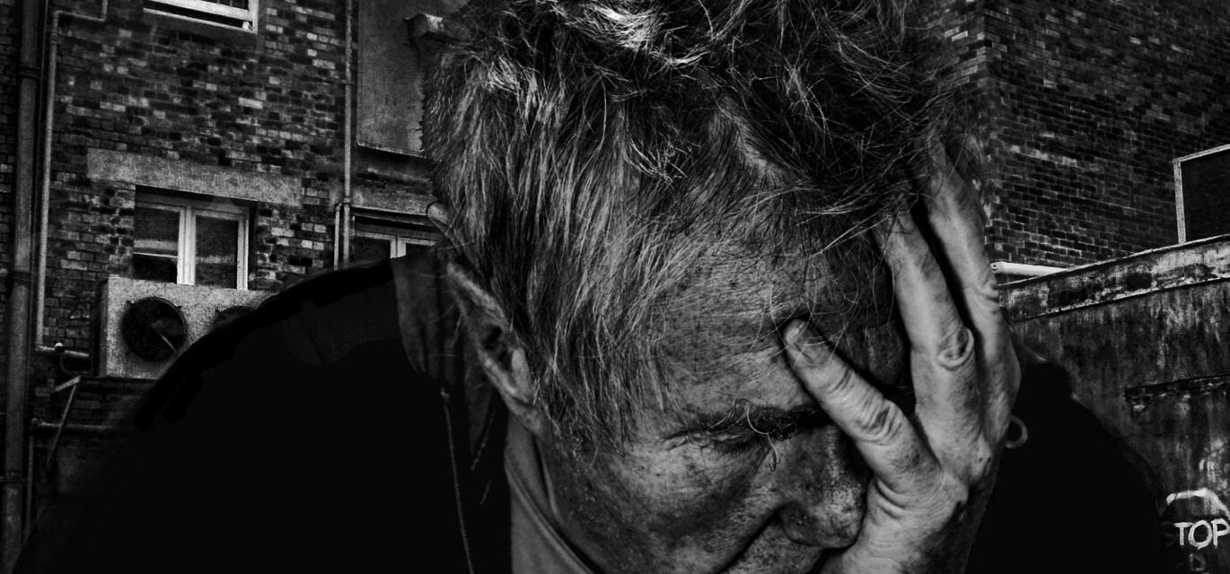 Man with hand over face