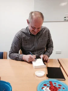 Ian Sutherland signing a book