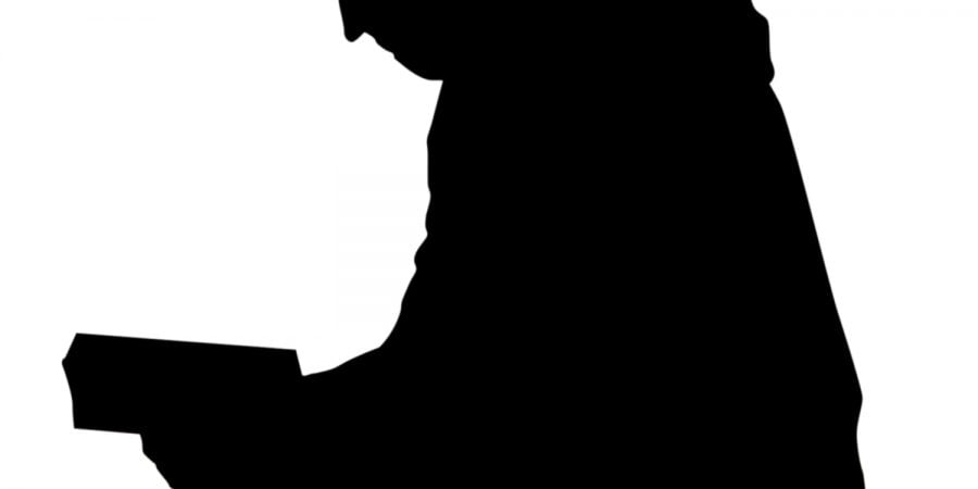SIlhouette Of A Man Reading A Book