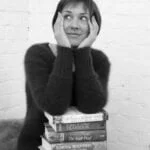 Jane Davis with pile of books