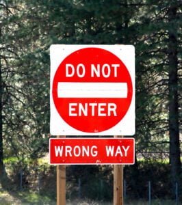 sign saying "do not enter - wrong way"