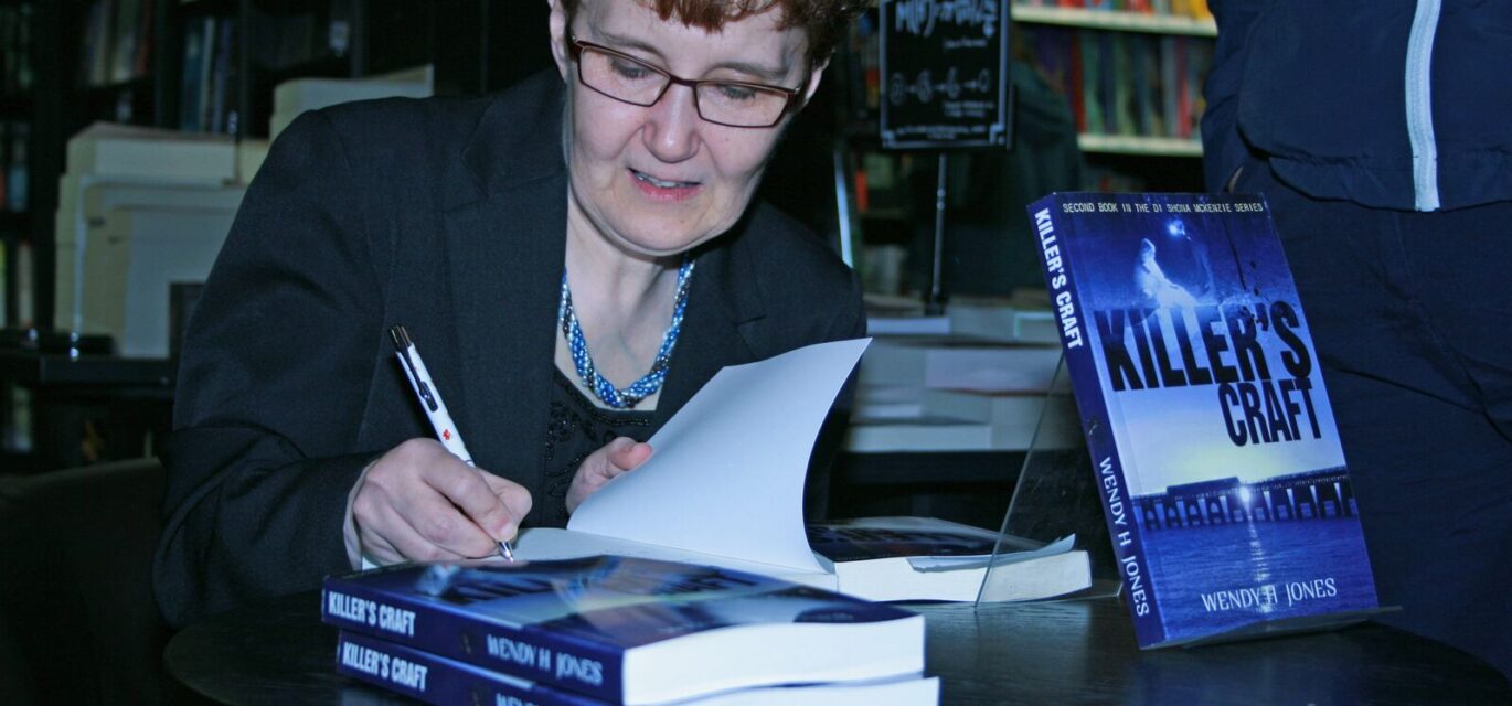 Photo of Wendy H Jones signing books