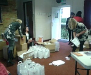 Photo of Triskele authors packing goody bags