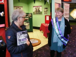 Photo of Lucienne with a buyer of her book