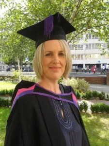 Head shot of Eden Sharp in academic gown