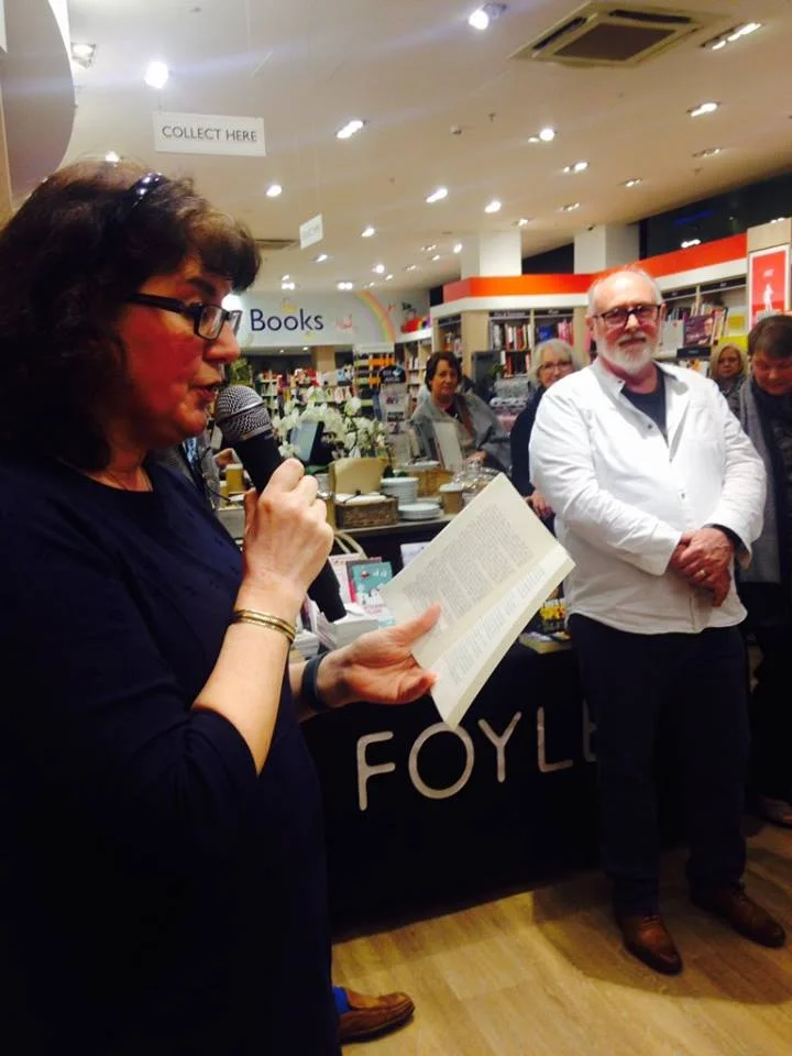 Debbie reading, David listening in photo