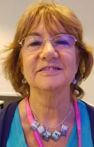 Headshot of Anne with necklace and earrings