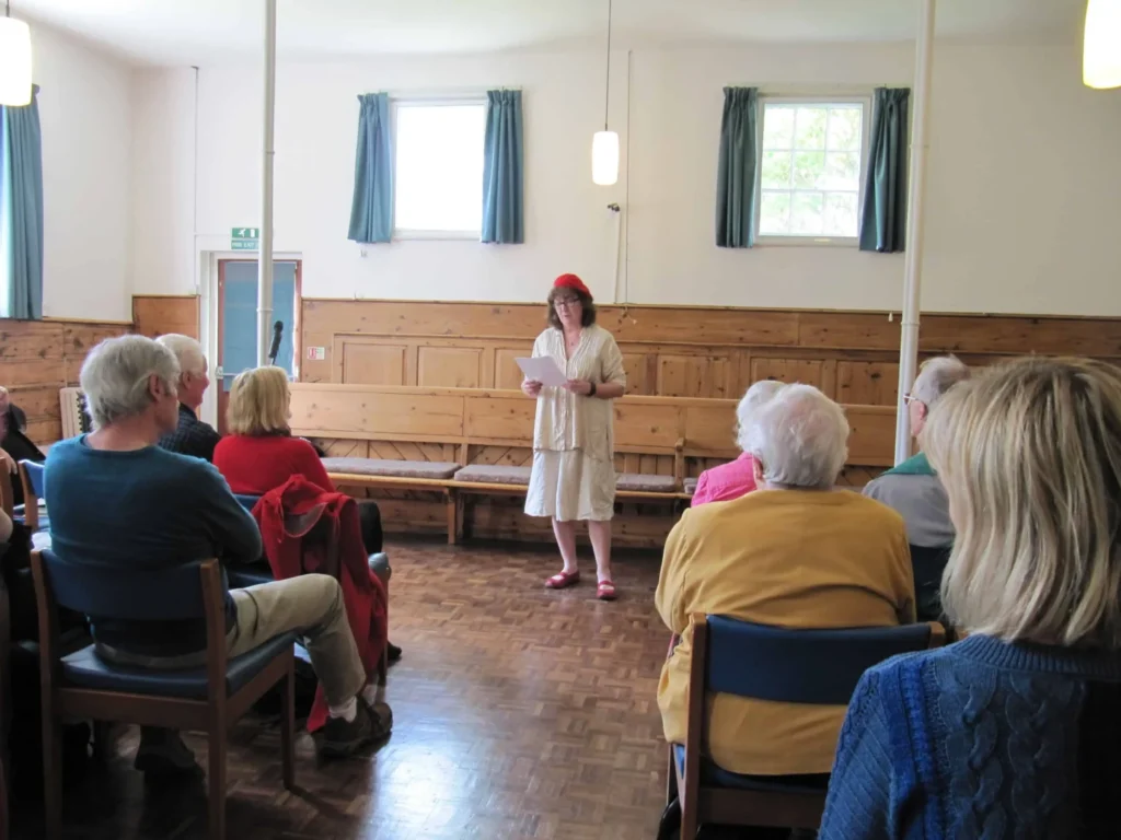 Debbie reading in front of an audience