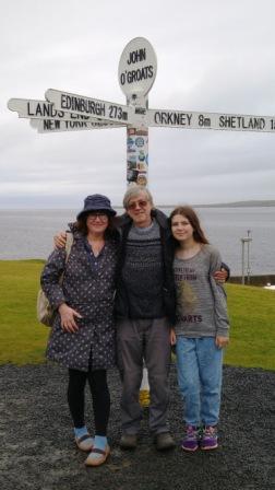 Debbie Young with family beneath road sign at John O'Groats