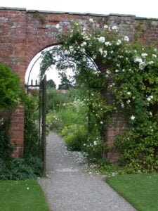 Photo of gate opening into a beautiful garden