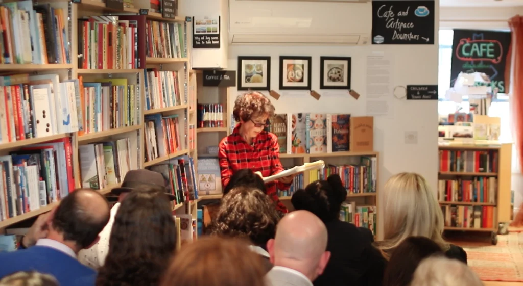 Photo of an author reading to a group in a bookshop