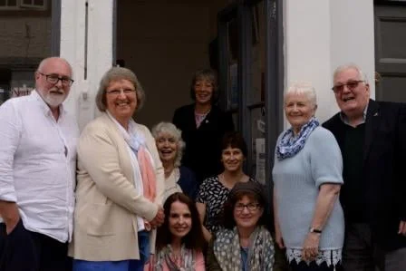 Group photos of authors in shop doorway