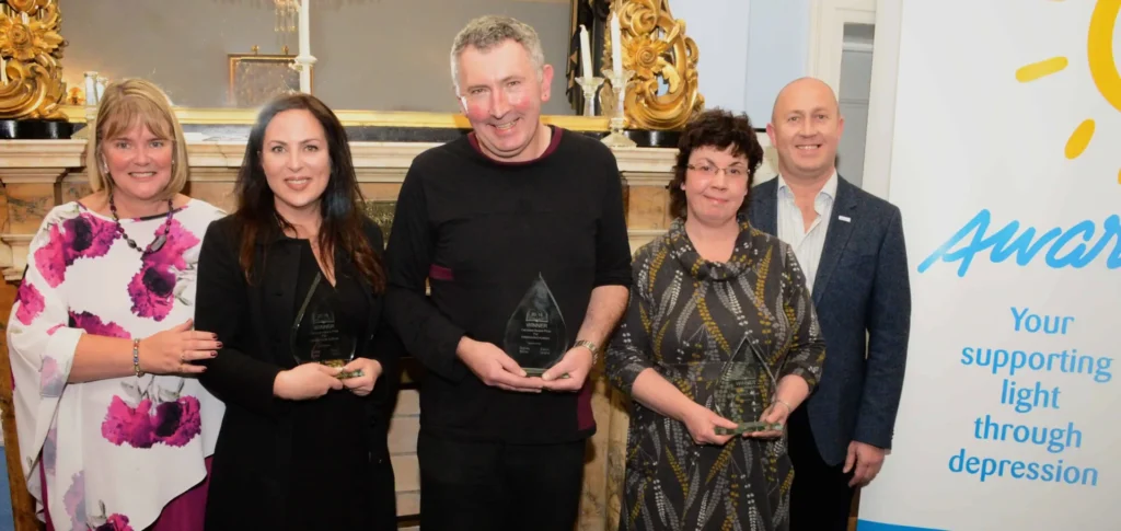 5 people celebrating winning an award