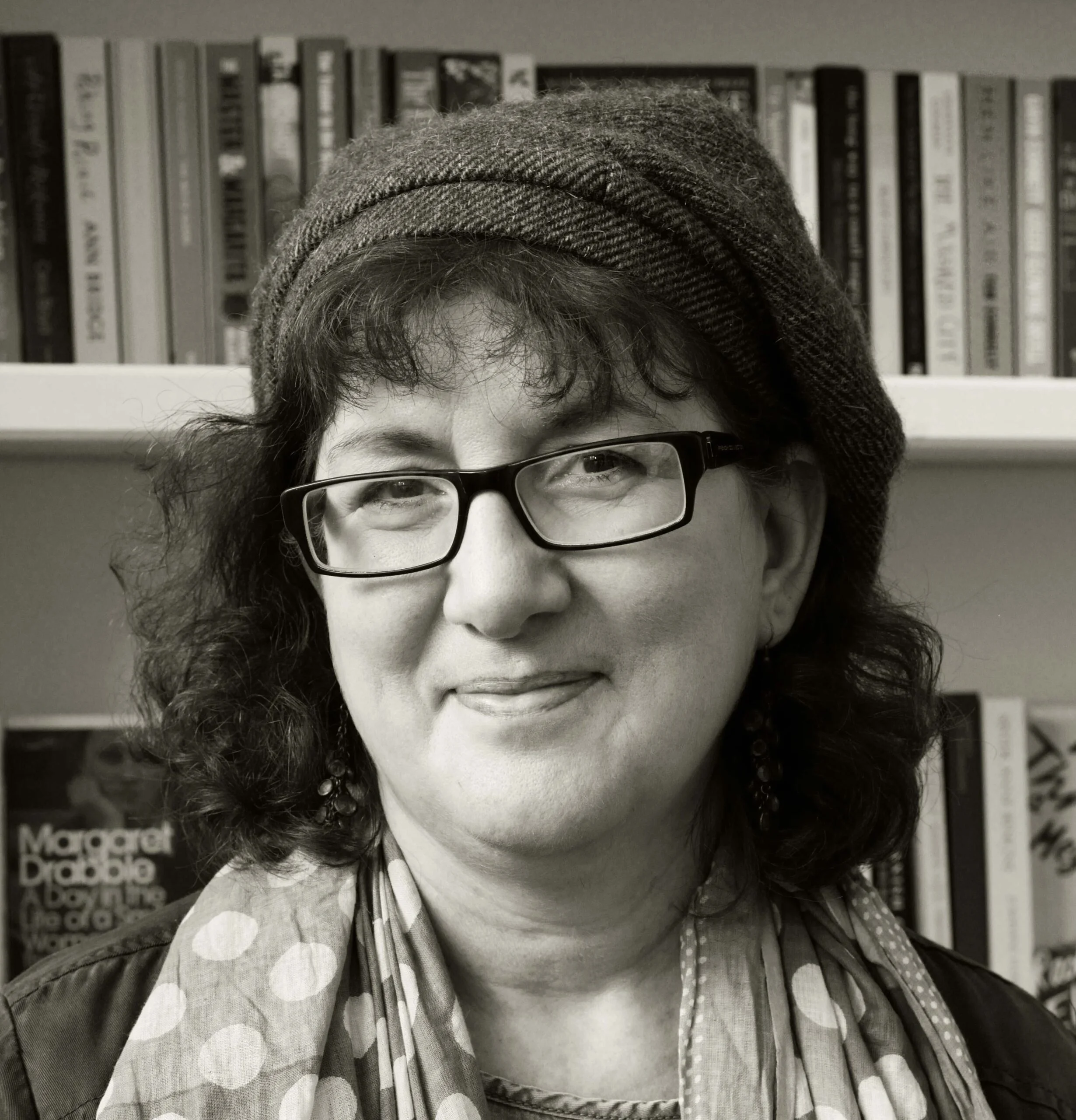 Headshot Of Debbie Young In Front Of Bookshelf