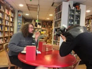 Here I am at Oxford's legendary Albion Beatnik bookstore: but while we may be posing for photoshoots, are we actually buying our books in bookstores?