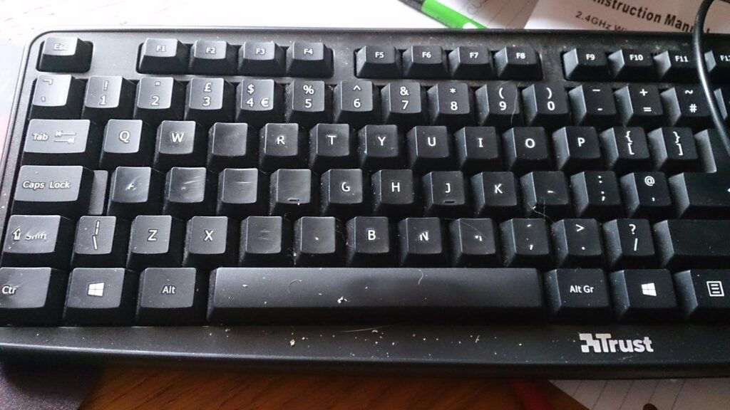 Photo of keyboard with lots of letters rubbed off