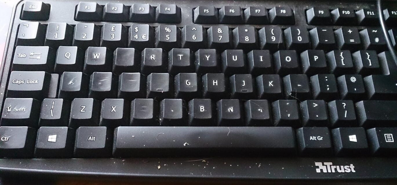 Photo of keyboard with lots of letters rubbed off
