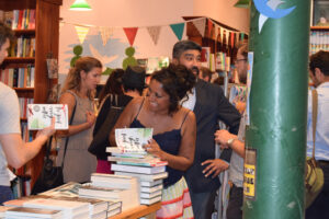 Author signing books in a store