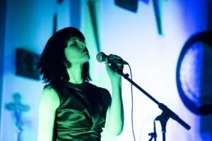 Jessica Bell at a microphone singing