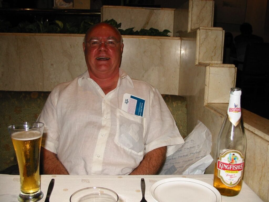 photo of John in a restaurant with a ticket sticking out of his shirt pocket