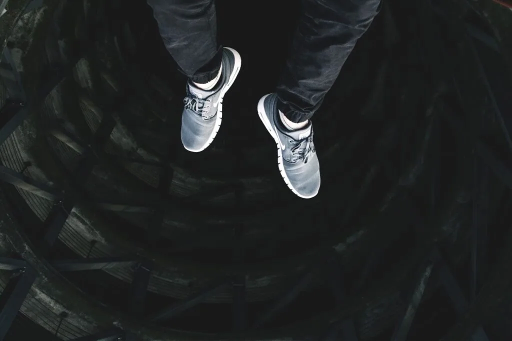 image of someone falling feet first down black hole