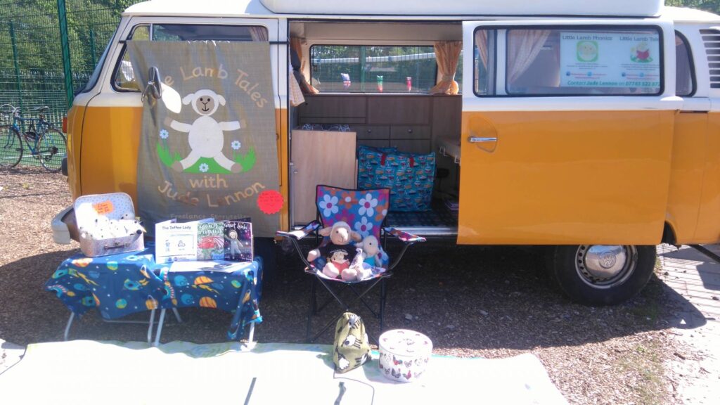 image of books and props with camper van