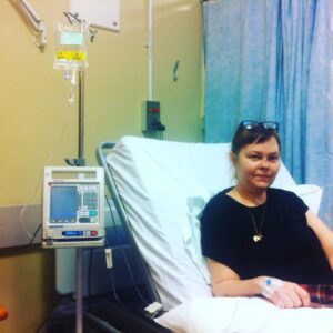 photo of Lisa on drip in hospital bed