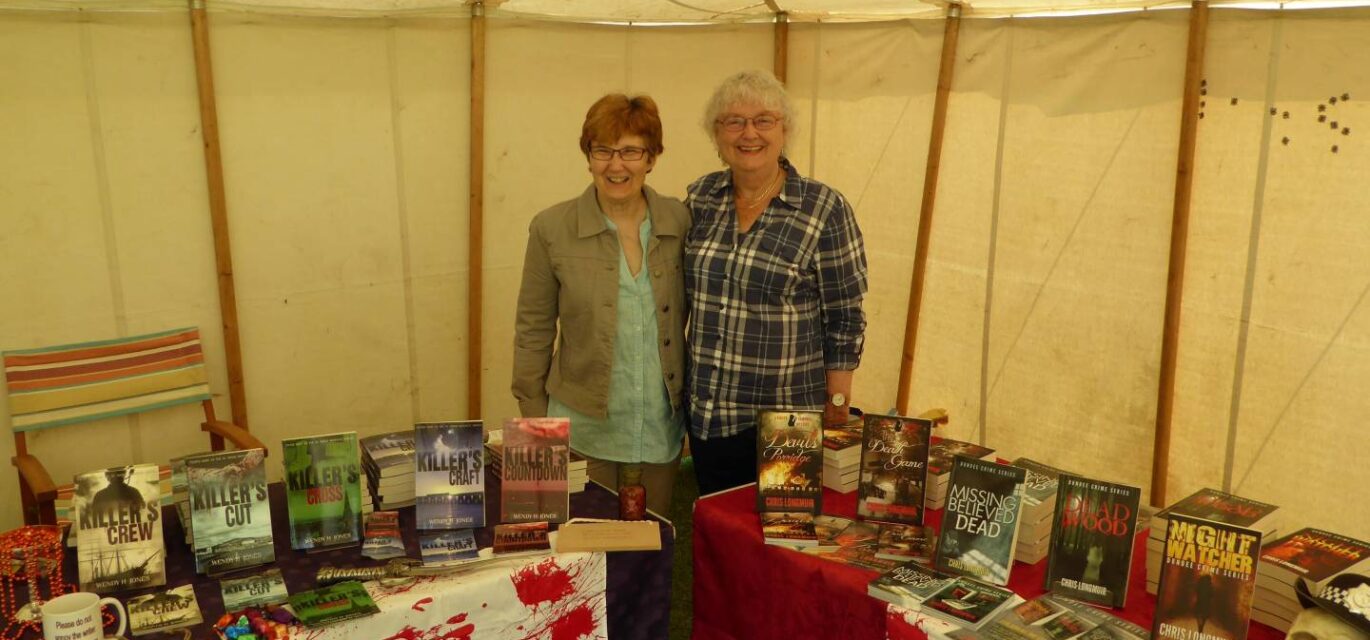 Photo of two authors with their stalls