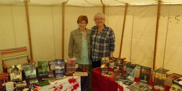 Photo of two authors with their stalls
