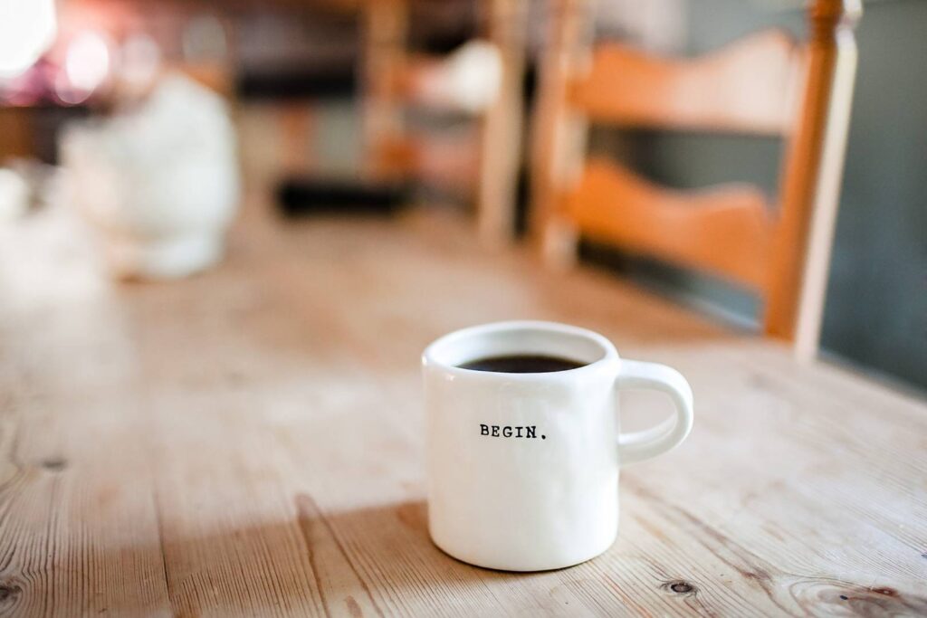 Coffee cup with "begin" lettered on it