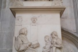 church tomb showing man reading to children