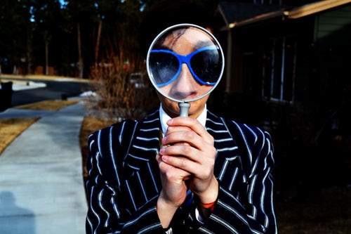 Photo Of Person Looking Through Magnifying Glass