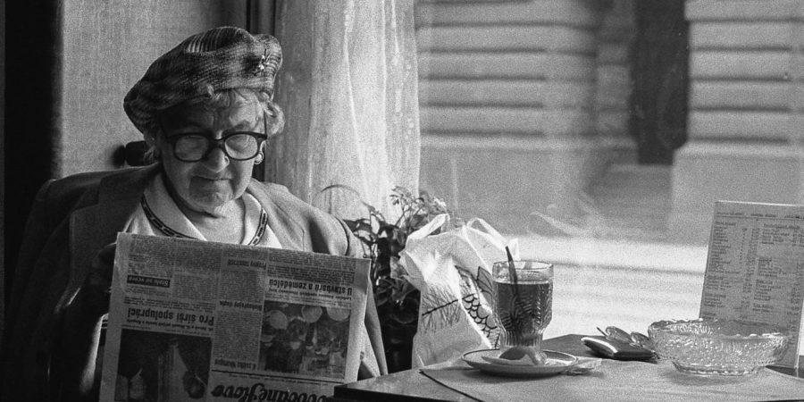 Image Of Old Lady Reading A Newspaper In A Vintage Photo