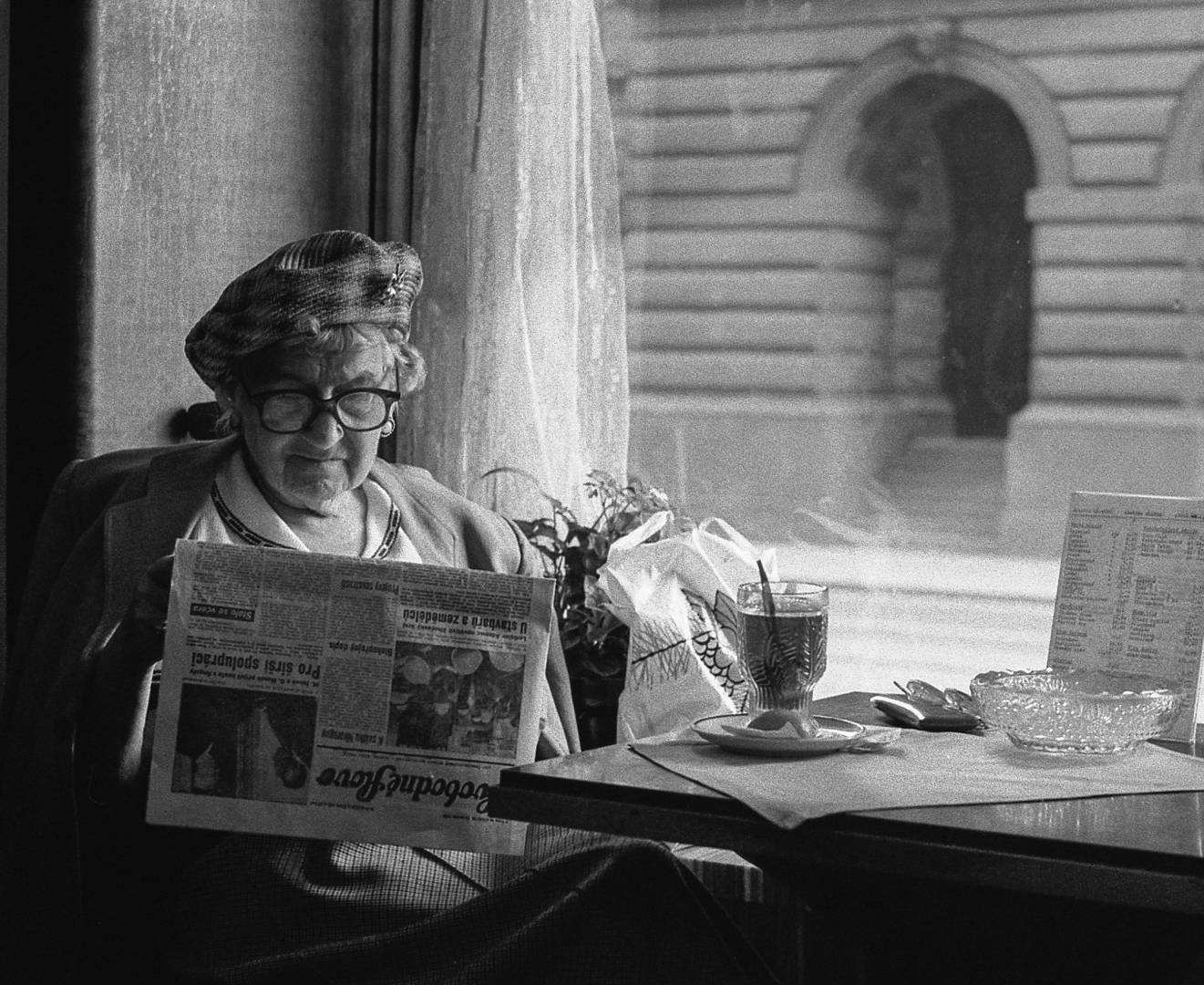 Image Of Old Lady Reading A Newspaper In A Vintage Photo