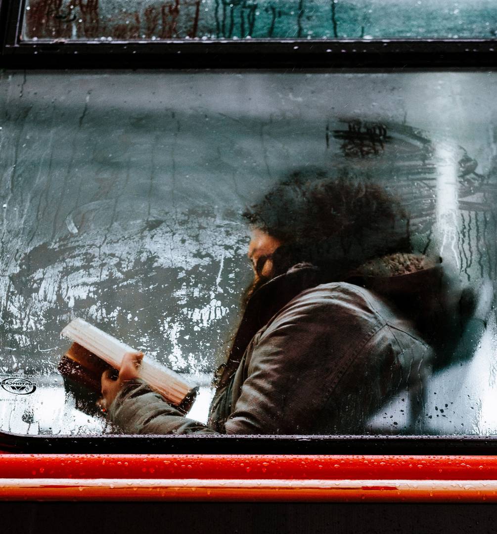 Girl Reading Book On Bus