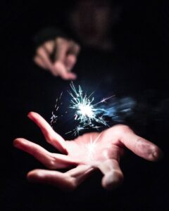 picture of sparkler with sparks in palm of hand