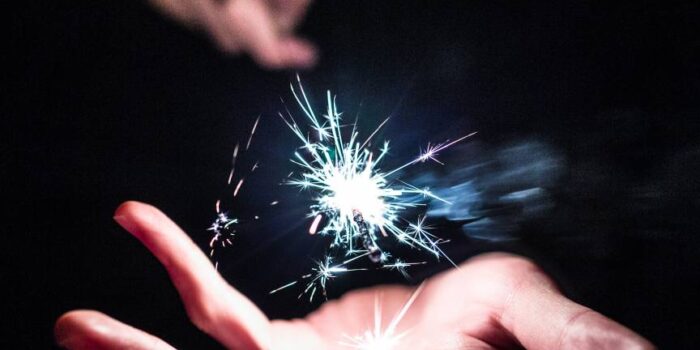picture of sparkler with sparks in palm of hand