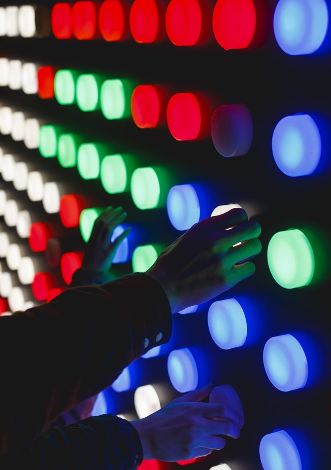 Photo By Katya Austin On Unsplash Of Hands On Different Coloured Lights Looking Like An Experiment