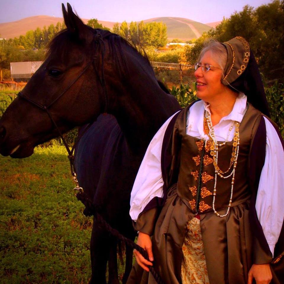 photo of Emily Cotton in medieval dress with horse