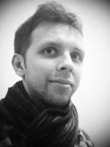 headshot of Adam Nicholls