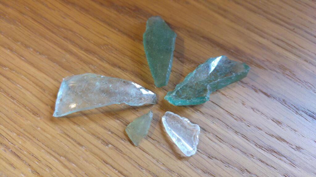 five pieces of seaglass arranged like the petals of a flower